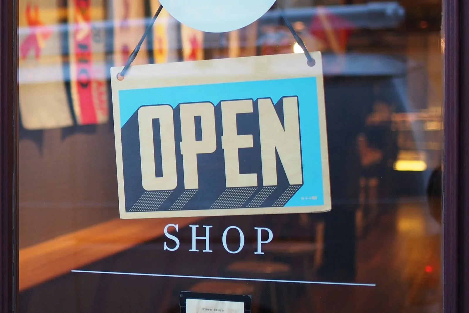 An OPEN sign hanging in a shop window